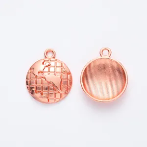 Detailed close-up of rose gold alloy globe charms showing 3D world map and textured back