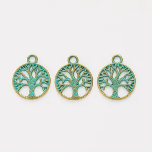 Detail van drie vintage bronzen levensboom hangers met een antieke groene afwerking