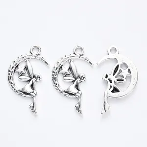 Detailed view of three vintage silver moon and angel charms for DIY jewelry making