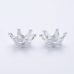 Macro shot of silver vintage crown alloy charms with intricate base detailing