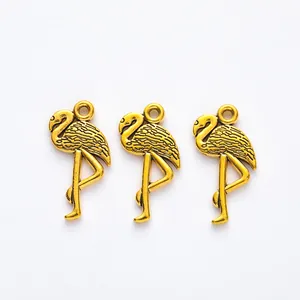 Three vintage gold flamingo pendants with feather texture for DIY jewelry making