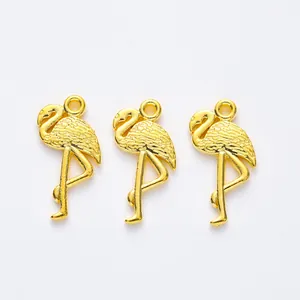 Three gold-plated flamingo metal charms with detailed feather textures for DIY jewelry