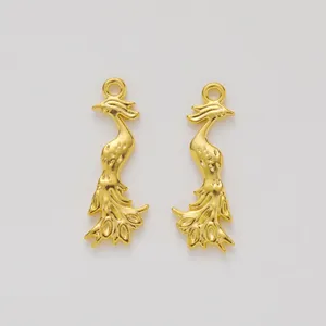 Macro detail of pair golden peacock alloy pendants with fine textures for DIY jewelry