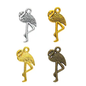 Set of four vintage flamingo alloy pendants in silver, gold, and bronze metallic finishes