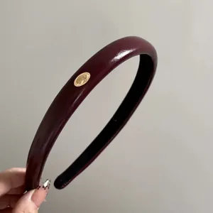 Vintage burgundy leather headband with gold metal buckle detail and high crown fit