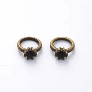 Detailed view of two vintage bronze crown-shaped ring bases for DIY jewelry making