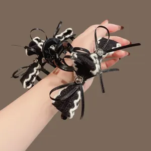 Elegante pinza per capelli nera con strass e fiocco di velluto per donne