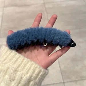 Détail de la pince banane en peluche bleue avec dents pour coiffure queue de cheval