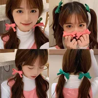 Detailed views of soft plush bow hair clips in vibrant pink and green for elegant styling