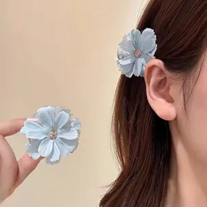 Light blue fabric flower hair claw clip with pearl center for elegant summer hair styling