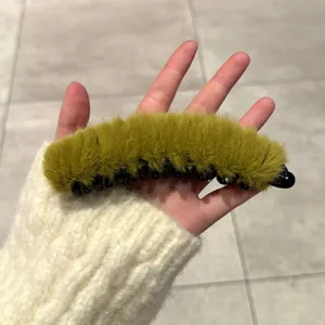 Détail de la pince banane à double nœud en peluche vert olive avec des dents en plastique