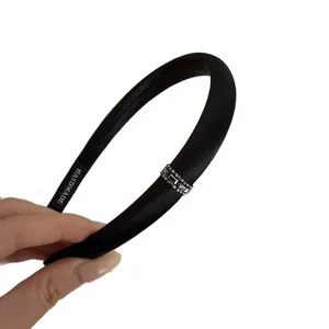 Elegant black satin headband with silver rhinestones and beads on white background