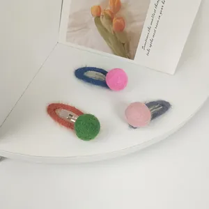 Three-piece set of mohair color-block hair clips with plush wool balls in a cute style