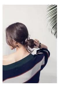 Floral hair scrunchie with white pearls styled on a low bun hair look