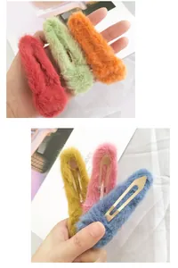 Detail of plush faux fur BB hair clips showing soft texture and metal snap closures