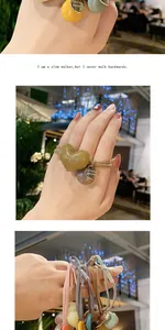 Detail of high-elasticity hair ties with resin heart beads and engraved gold pendants