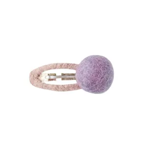 Pink plush oval hair clip with a purple felt ball decoration on a white background
