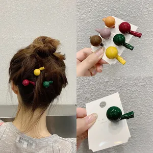 Detail of candy-colored spherical mini hair clips in various bright resin finishes