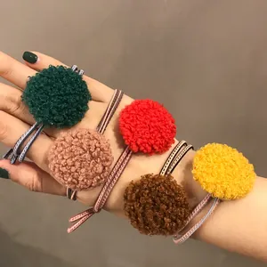 Fünf farbige Plüsch-Haargummis mit flauschigen Pompons und elastischem Gummiband