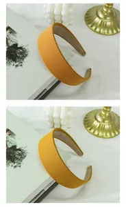 Macro detail of wide yellow fabric headband with rich texture and premium inner lining