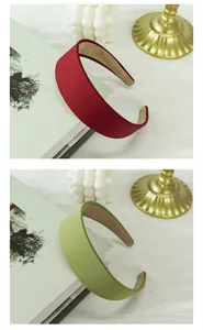 Detail of wide matte fabric headbands in burgundy and green with non-slip lining