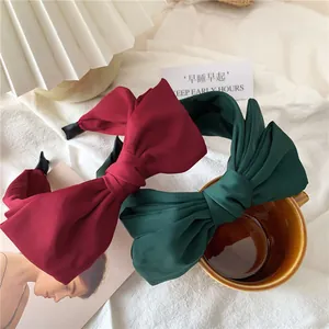 Dual-layer large bow headbands in burgundy and dark green matte satin fabric