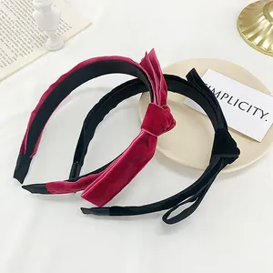 Elegant velvet headband with vintage French knot bow in classic red and black colors