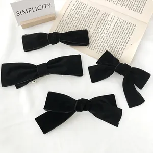Elegant black velvet bow hair clips set with various styles and matte finish for women