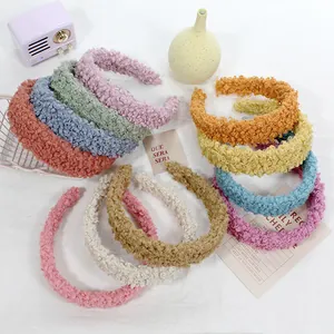 Variety of colorful fuzzy lamb wool headbands showing soft plush texture and candy colors