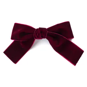 Elegant burgundy velvet bow hair clip with vintage handmade ribbon on white background