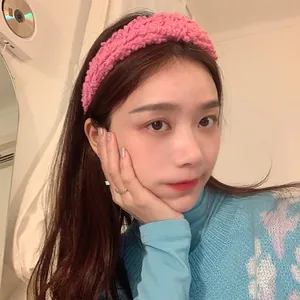 Fuchsia lamb wool wide headband with soft plush texture worn by a model in casual setting