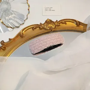 Chic light purple knitted wool hair clip on a vintage mirror with elegant decor