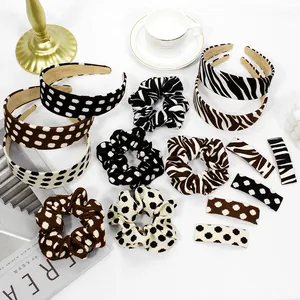 Detailed view of leopard and polka dot scrunchies and hair clips on a table