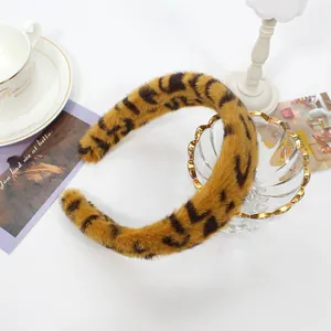 Detail of plush leopard print headband with soft faux fur texture for winter style