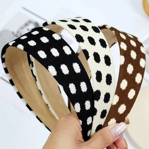 Close-up of three retro polka dot wide headbands featuring soft textured fabric and non-slip lining