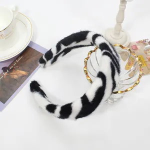 Detailed view of plush zebra print headband with soft faux fur texture and black-white stripes