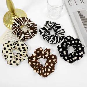 Detailed set of leopard and polka dot scrunchies in a premium lifestyle setting