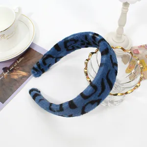 Detail of blue faux rabbit fur headband with black leopard print in a cozy setting