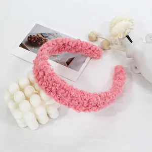 Detailed texture of pink lamb wool headband on minimalist decorative background