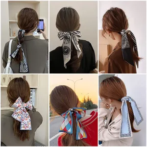 Detail of elegant satin hair scarf designs showing various floral and geometric patterns