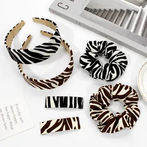 Zebra print hair accessories set with headbands, scrunchies, and clips in minimalist style