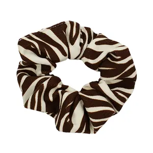 Elastic zebra print scrunchie in brown and cream velvet fabric for women hair styling