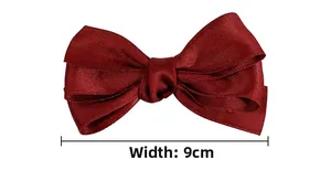 Detail view of burgundy triple-layered ribbon bow hair clip showing 9cm width dimension