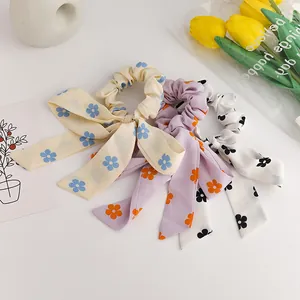 Floral chiffon scrunchies with long ribbons in three pastel colors for hair styling