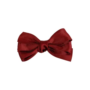 Elegant wine red triple layer bow hair clip with textured ribbon in a minimalist style