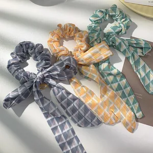 Three-piece geometric pattern scrunchie set with bow detail in soft woven fabric