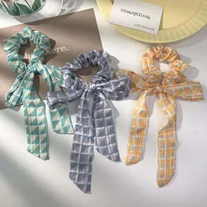 Three-piece set of geometric pattern bow scrunchies with long ribbons in pastel colors