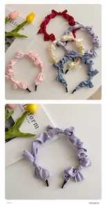 Detail of five colorful pleated satin bow headbands with smooth silk texture and soft shine