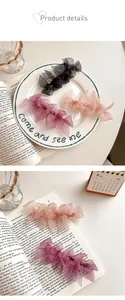 Detail showing layered sheer tulle bow hair clips in black, pink, and purple colors