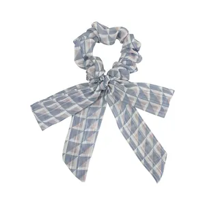 Plaid ribbon scrunchie with geometric diamond pattern in blue and pink tones